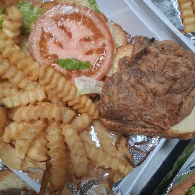 Pork chops with mayo, lettuce tomatoes.